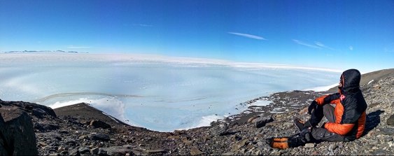A researcher sits at the edge of a glacier at Patriot Hills, Antarctica