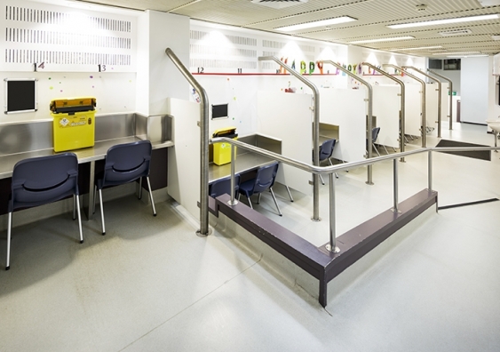 Empty booths in the injecting room with chairs and stainless steel desks