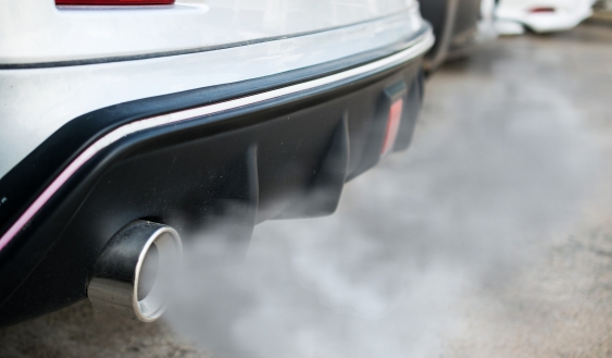 a car exhaust emits smoke and fumes
