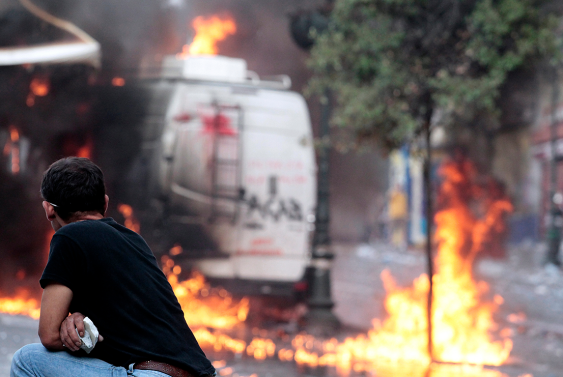 A van burns during protests in Greece