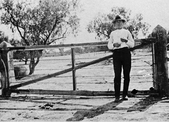 Police officer standing by the gate at the border of New South Wales in 1919