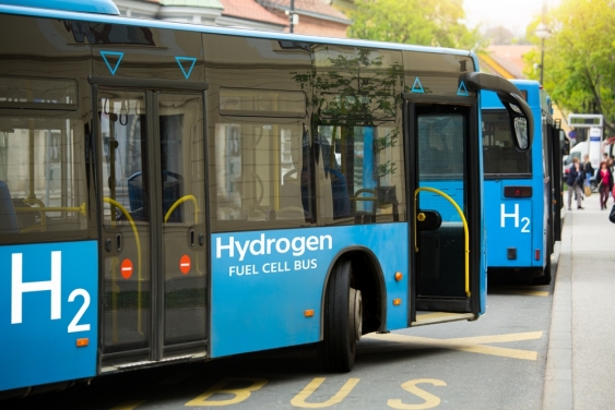 Two hydrogen powered busses in a city street
