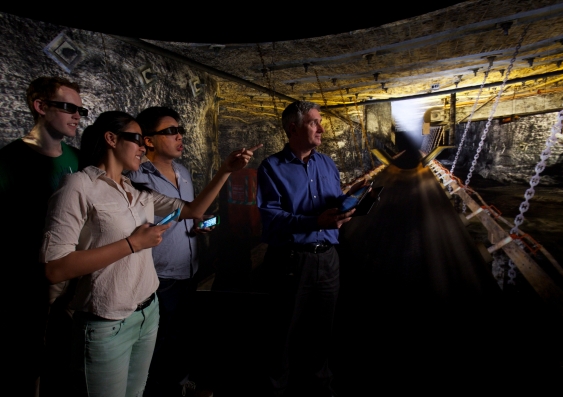 Three students with Paul Hagan, Head of UNSW’s School of Mining Engineering, at the school’s virtual reality mining lab.