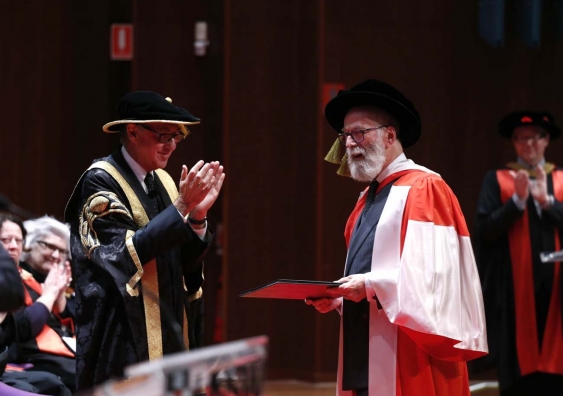 John Kaldor receives his honorary doctorate from UNSW Chancellor David Gonski.