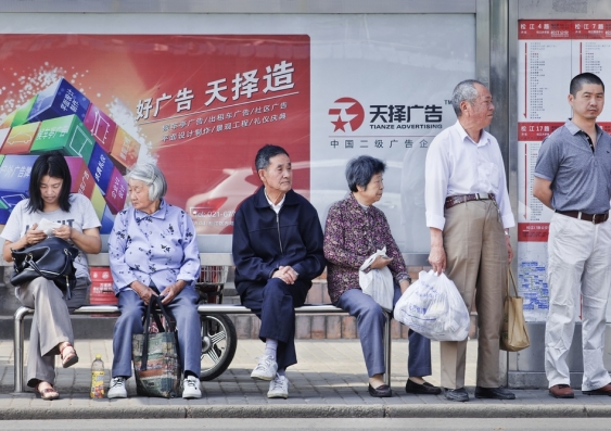 Elderly people at a bus stop in Shanghai, China. Photo: Shutterstock