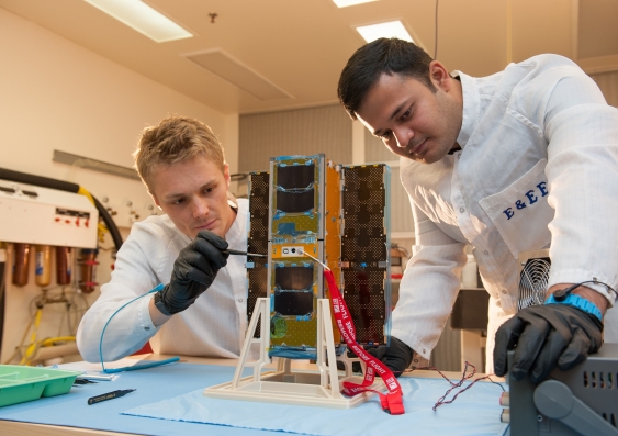 UNSW Canberra space test engineers Philippe Lorrain and Arvind Ramana carrying out initial acceptance tests on the BRMM (Buccaneer Risk Mitigation Mission) spacecraft bus from Pumpkin, Inc.Photo: UNSW Canberra