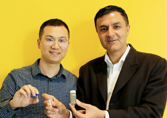 Dr Jianbo Tang and Professor Kourosh Kalantar-Zadeh with some samples of liquid metal droplets produced after heating a bismuth-tin alloy and shaking in water. Picture: UNSW