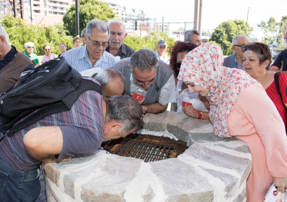 Members of Auburn's Turkish community gather round Sydney's sonic well. Photo: Allan Giddy