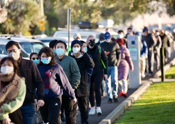 People line up in St Kilda, Melbourne, to get their COVID-19 vaccinations. Photo: Shutterstock