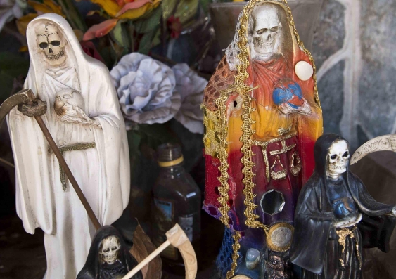 Images of San La Muerte (Saint Death) at the entrance to the town of Arteaga, in Mexico’s Michoacán State – home to the leader of the notorious Knights Templar drug cartel. Photo: Ronaldo Schemidt/Getty Images