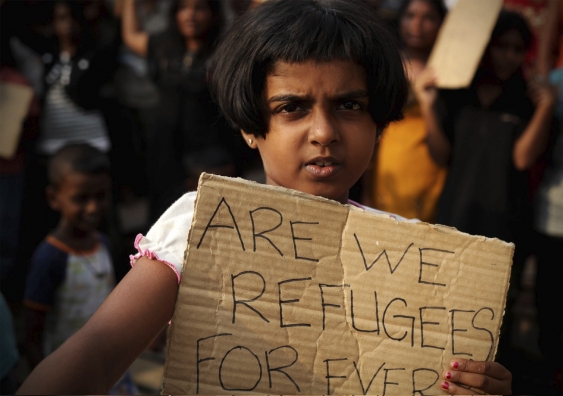 A Sri Lankan asylum seeker holds a placard during a protest. Photo IStock