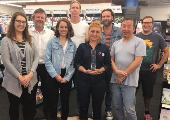 UNSW Bookshop staff (from left) Rosie Taprell, Mark Halliday, Stephanie Gardner, Steve Pott, Emily Doherty, Vaughan Williams, William Zhang and Adam Kelly with the Campus Bookseller of the Year 2017 trophy.