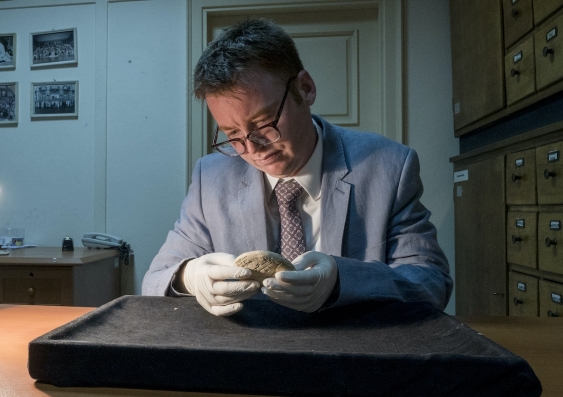 Daniel Mansfield holds Si.427 in a Turkish museum. The ancient tablet has implications for the history of mathematics. Photo: UNSW Sydney.