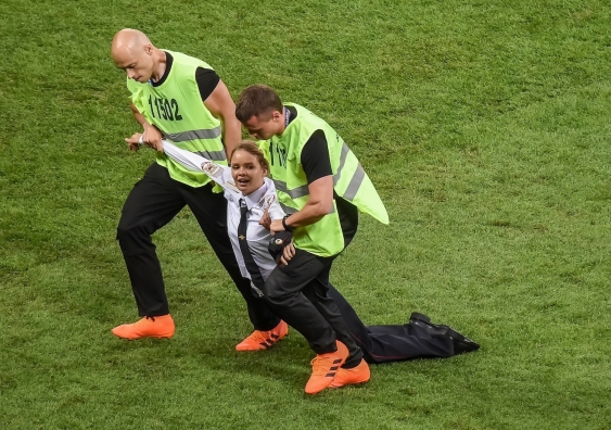 Security personnel drag a protester off the field during a World Cup football match. Photo: Shutterstock