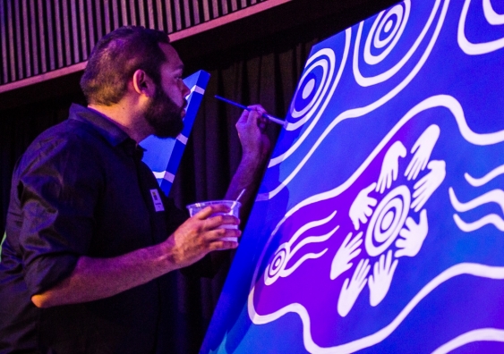 Artist Dennis Golding works on the painting “Pathways to Our Right” at the launch of the Australian Human Rights Institute at UNSW Sydney. Photo: Diane Macdonald