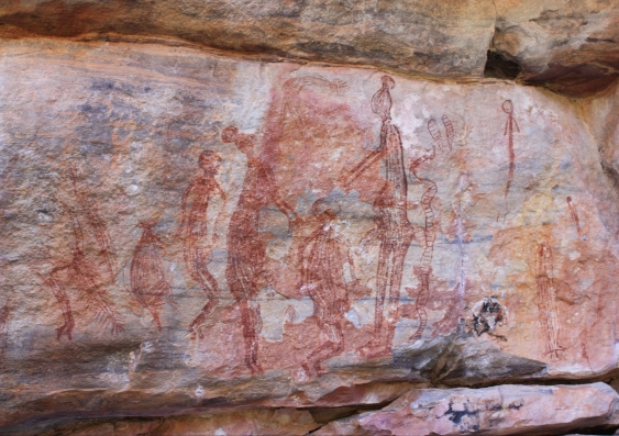 Ancient human figures painted in red on a rock shelter in northern Australia (Source: Google Art Project, Griffith University). Wikimedia Commons, CC BY-SA
