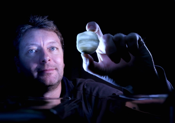 Professor Andy Baker with part of a stalagmite from Roaring Cave. Photo: Grant Turner/Mediakoo