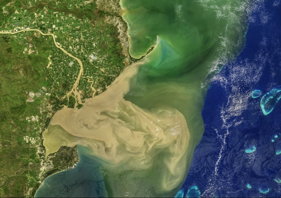 Associate Professor Shane Keating has received an ARC Linkage grant to measure upper ocean currents. This image depicts floodwaters from the Burdekin River flowing into the Great Barrier Reef after the February 2019 Queensland floods, which will be studied as part of the ARC Linkage project. Photo: NASA Earth Observatory