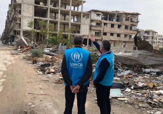Inspecting war-damaged housing in Syria.