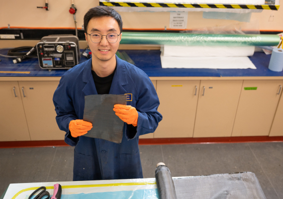 UNSW Canberra researcher Di He with a sample of carbon fibre recycled using a method he developed. Image: UNSW Canberra