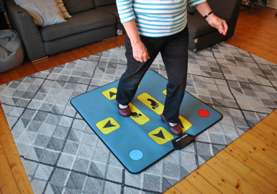 smart±step is connected to a television screen and once a game of choice is selected it requires the person to step on target panels on a step mat, just like one would with a game controller. Photo: NeuRA