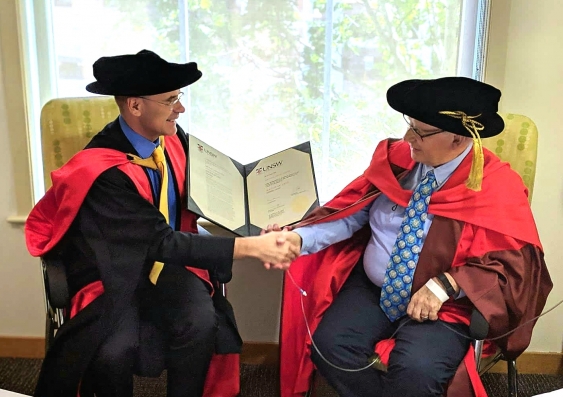 UNSW Dean of Law, Professor George Williams (left) confers the honorary doctorate on Emeritus Professor Michael Coper.