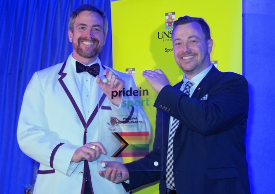 UNSW Vice-Chancellor and President Attila Brungs holds a Pride in Sport plaque with Pride in Sport Project Officer Ben Cork. Pride in Sport is a national not-for-profit program specifically designed to assist sporting organisations with LGBTIQ+ inclusion. Photo: UNSW Sport