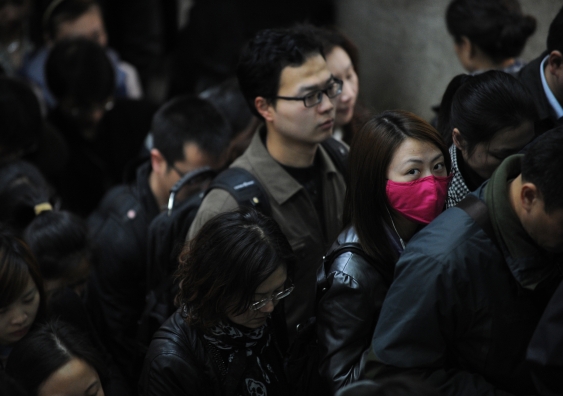 A woman wears a mask on the Metro in Shanghai in 2013 during a H7N9 avian influenza outbreak. PETER PARKS/AFP/Getty Images