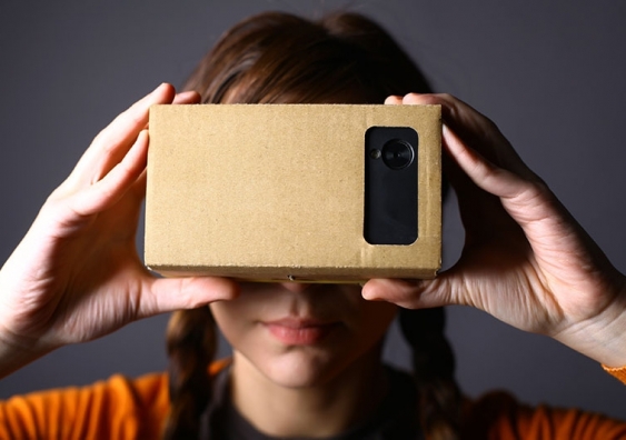 The smartphone is held to the face inside the Google Cardboard virtual reality box.
