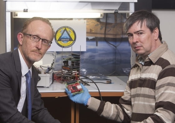 Professor Andrew Dempster (left) and Dr Eamonn Glennon of UNSW's Australian Centre for Space Engineering Research with an early version of their space-ready receiver. Photo: Quentin Jones