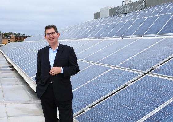 UNSW President and Vice-Chancellor Professor Ian Jacobs with solar PV arrays installed across rooftops at the UNSW Kensington campus.