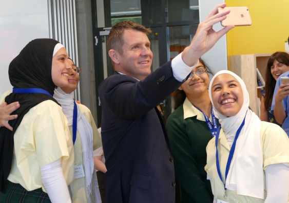 NSW Premier Mike Baird takes a 'selfie' with Year 10 students from Wiley Park Girls High School.