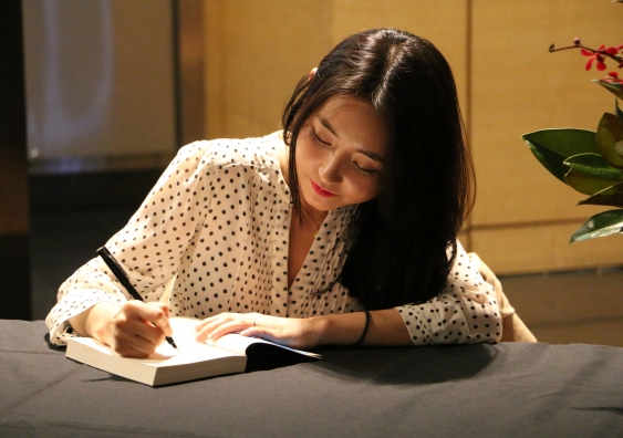 Yeonmi Park signs a copy of her book 'In Order to Live: A North Korean Girl’s Journey to Freedom' at the UNSW Sydney Writers' Festival event. Photo:  Marty Jamieson