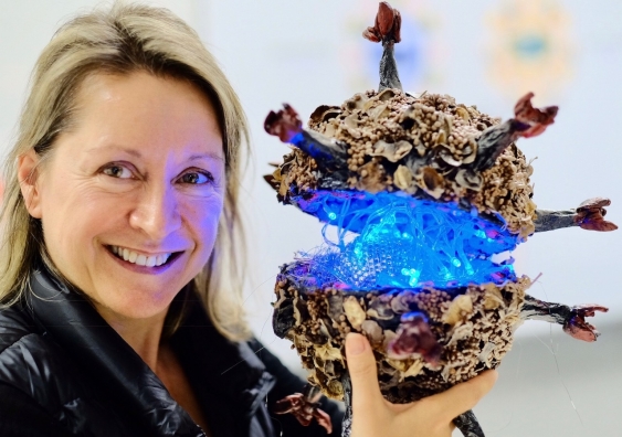 Dr Erica Tandori, legally blind artist with her model of HIV. Photo: Stephen Blake