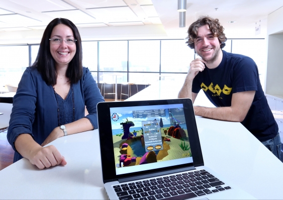Isabella Dobrescu and Alberto Mottta with their Playconomics game. Photo: Grant Turner / Mediakoo