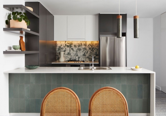 The kitchen splashback, the front of the island bench and the tubular light fittings on display in the apartment were manufactured using green ceramics.