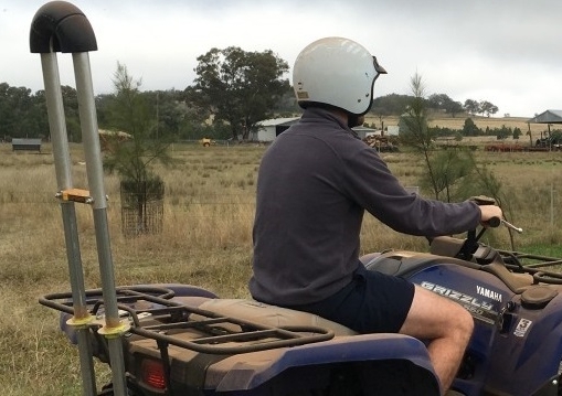 Rider wearing a Quad bike helmet with Quadbar Operator Protective Device attached to bike. Image: UNSW