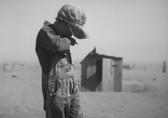 A young boy covers his mouth during a dust storm on farm. Cimarron County, Oklahoma. April 1936. Image: Arthur Rothstein; The Library of Congress, Prints & Photographs Division