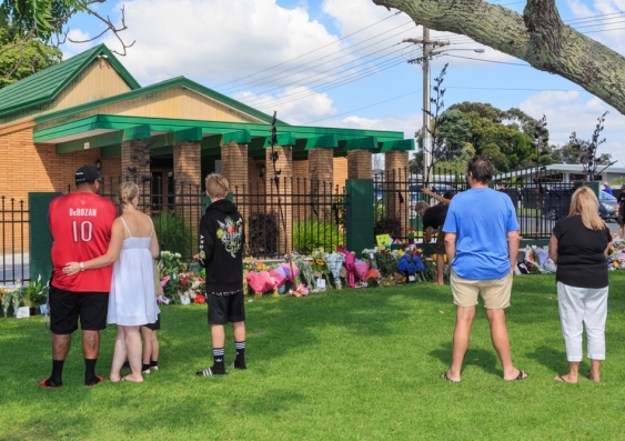 Saddened New Zealand citizens at Tauranga Mosque which became a memorial for the victims of the Christchurch terror attack. Image from Shutterstock