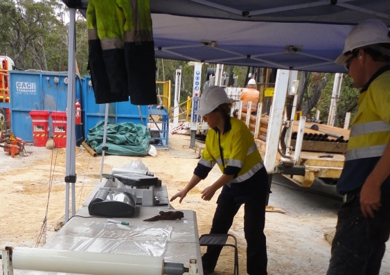Katarina David (left) of the UNSW Connected Waters Initiative preserves samples of moist rock at a drilling site near Sydney for later testing in the laboratory.