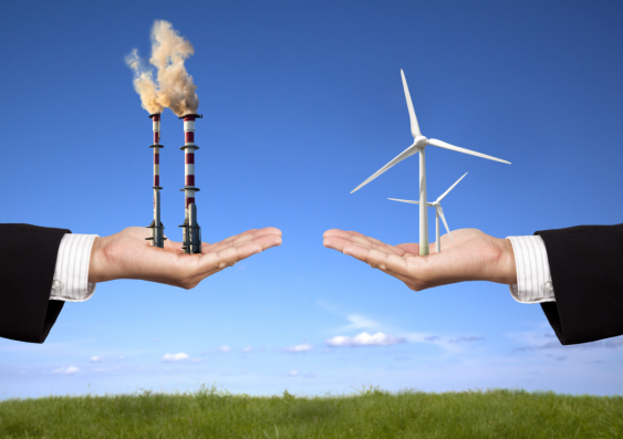 Two hands, one holding fossil fuels and the other with renewable energy