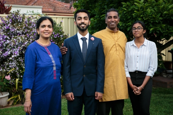 UNSW Law student Sanjay Alapakkam standing with three of his family members.