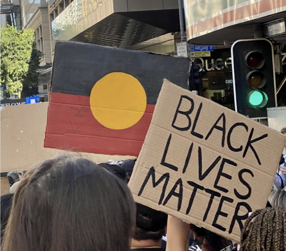 People holding 'Black lives matter' signage in Brisbane protest.