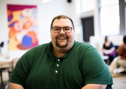 Plus size man smiling in an office setting