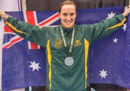 Dr Mandy Hagstrom with a medal and the Australian flag