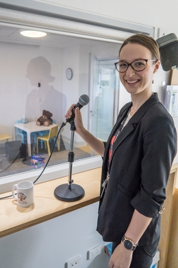 Dr Georgie Fleming stands behind a one-way mirror in a children's behavioural clinic