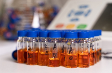 Vials with orange liquid in the lab