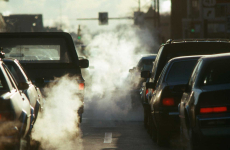 Cars in a traffic with visible pollution. 