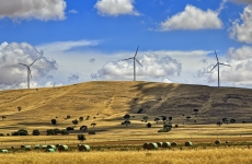 Windmills on a hill with fields in the foreground