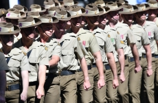 People in army uniforms marching in line